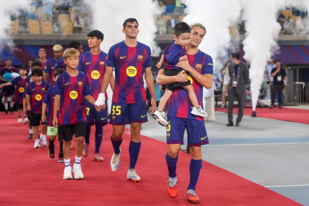 FC Barcelona players celebrate a goal during their 5-0 win over Daegu FC in a preseason friendly, featuring standout performances from Gavi and Rashford.